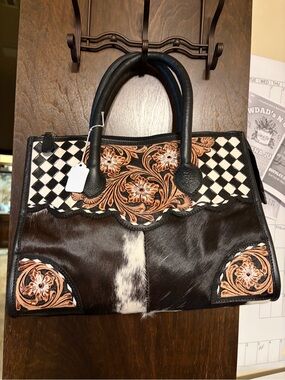 New cowhide handbag lots of room. With shoulder strap